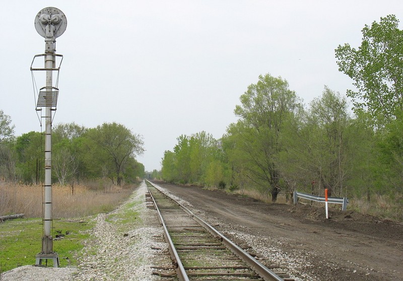 Looking west from the grade crossing in Carbon Cliff, IL.  The graded area on the north side of the mainline will be the new siding.  April 28, 2006.