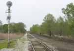 Looking west from the grade crossing in Carbon Cliff, IL.  The graded area on the north side of the mainline will be the new siding.  April 28, 2006.