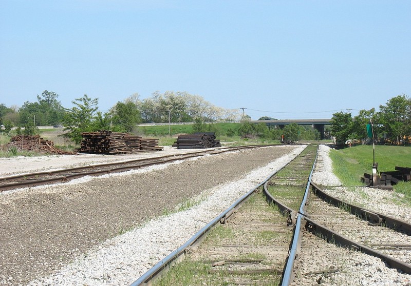 Looking east at the Anchor Lumber switch, you can see the ground has been graded for the 2nd siding to be placed between the current mainline and siding.  The mainline siding will be extended east to the road crossing at Carbon Cliff.   May 23, 2006.