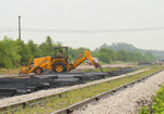 Positioning the new ties with a backhoe.  June 21, 2006.