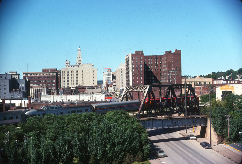 WB Football special crossing 3rd  St. in downtown Davenport.  The overpass in the foreground is the former wye connection to the abandoned 4th St. yard.