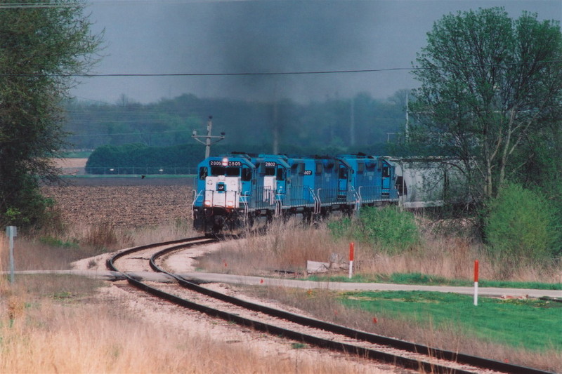 4 SD-38-2's in blue pull the CRIC out of Fairfax, Iowa in the spring of 2005.