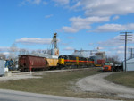 Westbound at Atalissa, passing two fertilizer cars at the dealer there.  Feb. 8, 2006.