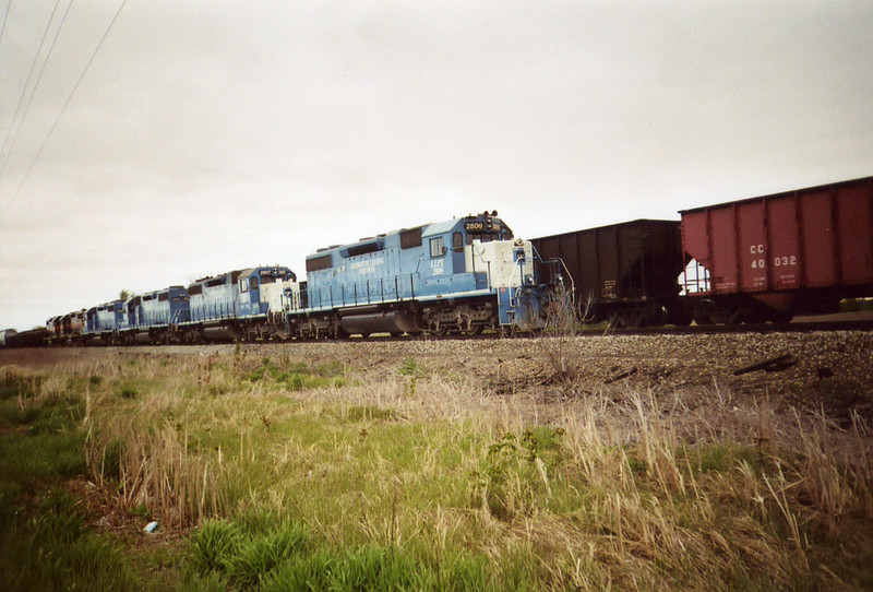 The westbound RI turn is in the clear at the west end of Twin States siding, while the coal empties head east on the main.  May 2, 2005.