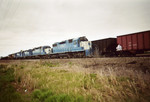 The westbound RI turn is in the clear at the west end of Twin States siding, while the coal empties head east on the main.  May 2, 2005.