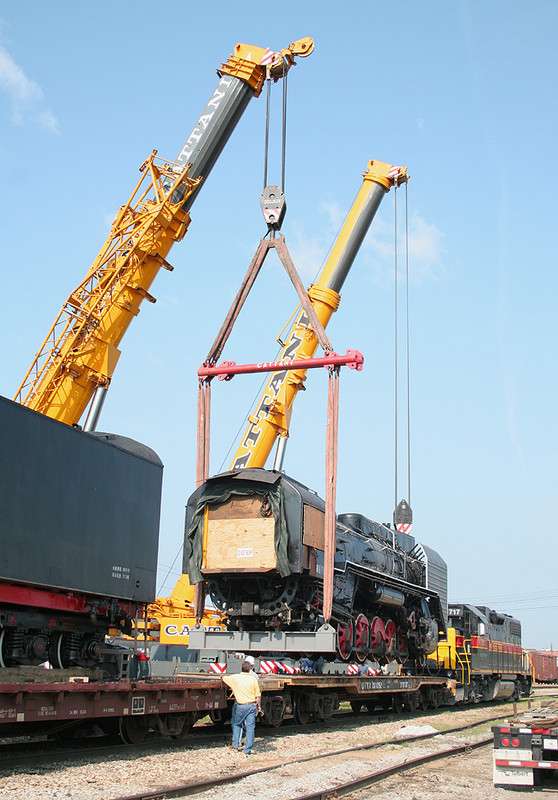 Locomotive 7081 is being lifted from its flatcar to be lowered onto the rails on 29-Jun-2006.