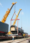 Locomotive 7081 is being lifted from its flatcar to be lowered onto the rails on 29-Jun-2006.