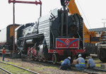 The 7081 is being lowered onto the rails under the watchful eye of several workers on 29-Jun-2006.