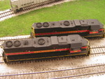 AFTER: Roof shot of upgraded units showing added details and removed engine room roof vent.  There aren't a lot of detail differences between the IAIS 700s, but horn type is one common variation.  During the Spring 2005 era I model, 703 had a Nathan P-3 and 709 had a Leslie RS5T.  Fortunately, SoundTraxx offers both as air horn selections with their Tsunami decoder, so programming them was simply a matter of setting CV115 to "5" (RS5T) or "11" (P-3).

I'm not sure why, but 709 also features four additional lift rings on the outer edges of the DB blisters.

Athearn's SmartStart warning labels were very difficult to see, and the SmartStart logos and most other informational decals on the long hood doors were missing entirely.  Those were added to the models using the updated Microscale set #87-551 for IAIS diesels.  Unfortunately, due to a Microscale mistake in the most recent updates, you need multiple sets to decal a single unit.