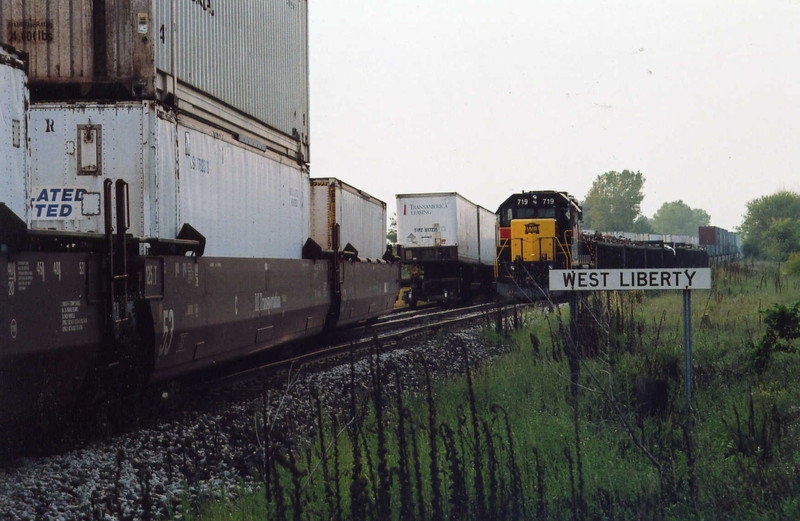 The east train and local are trading cars at West Lib.; the local has just pulled the TIPZ trailers out of the ramp and spotted them to the siding for the EB to pick up, meanwhile the local waits on the main with scrap for Wilton and stacks for the ramp.  Sept. 12, 2005