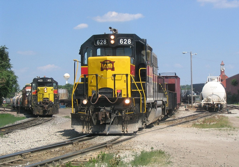 IAIS 403 and the Weed Spray train wait for IAIS 628 to switch out the west end of RI yard on 6/22/05.