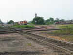 BN train is backing up the Bayard line, in the foreground is IAIS's main, crossing it is BN's Pacific Jct. line, and in the background is CBGR's geep.  Council Bluffs, June 21, 2006.