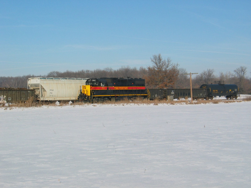 Eng. 711 on the Wilton Local passes the setout cars at the west end of N. Star siding, Dec. 21, 2005.