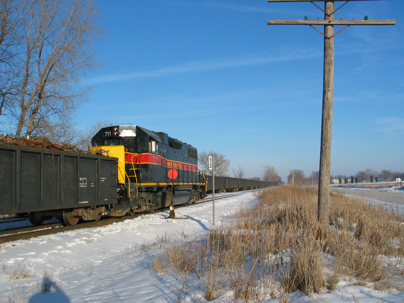 Wilton Local at the N. Star crossover, mp 208.5.  On the pocket are several 52' empty gons for Gerdau loading.