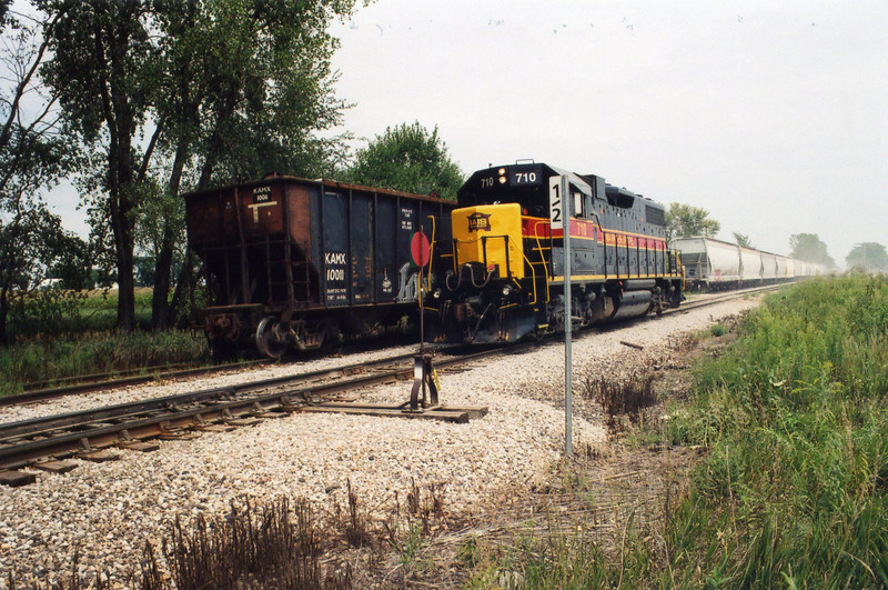 Wilton local and the KAMX scrap hopper.  N. Star crossover mp 208.5, Aug. 24, 2005.