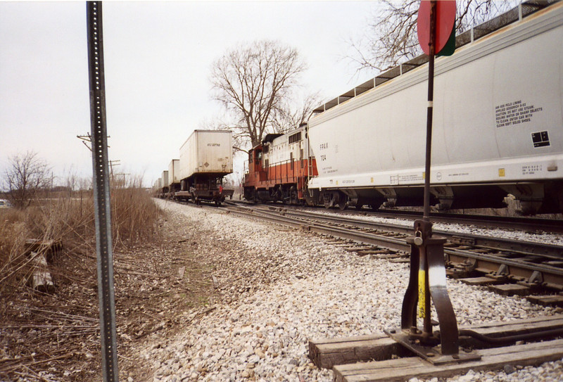 The west train heads for Iowa City while the local waits.  N. Star crossover mp 208.5, March 29, 2005