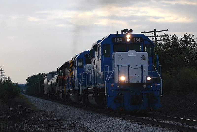 Just after daybreak on August 19th, 2007 A westbound RIIC train leaves Davenport, Iowa with 154 pointing the way.