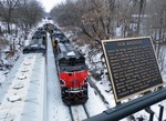 After setting out the grain and 507, and picking up the additional motive power, 513 takes headroom passed the town's railfan view platform dedicated to the first railroad to make it this far west from the big city in 1856.