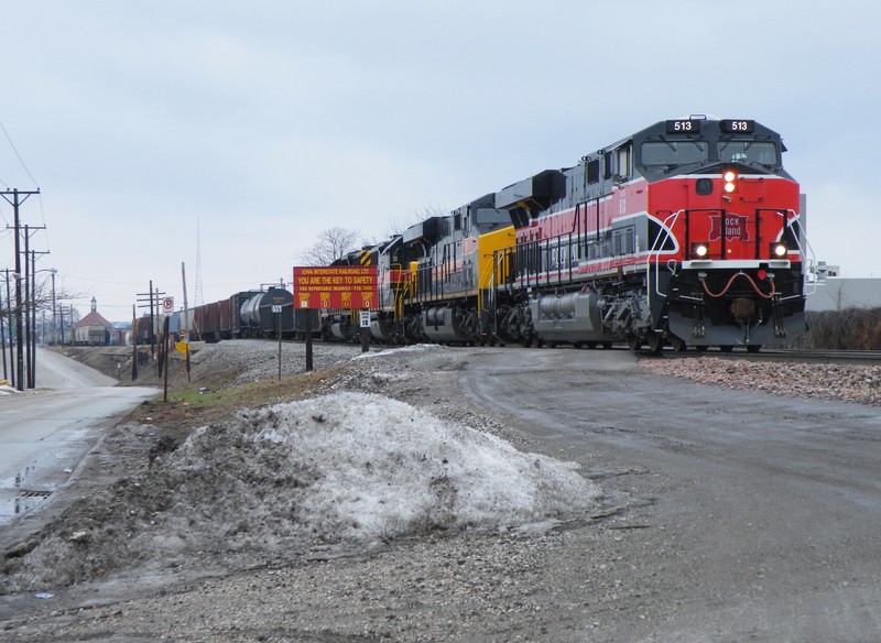 Shoving into the yard to make a setout, Iowa 513 passes the safety signage found at every Iowa yard across the system.