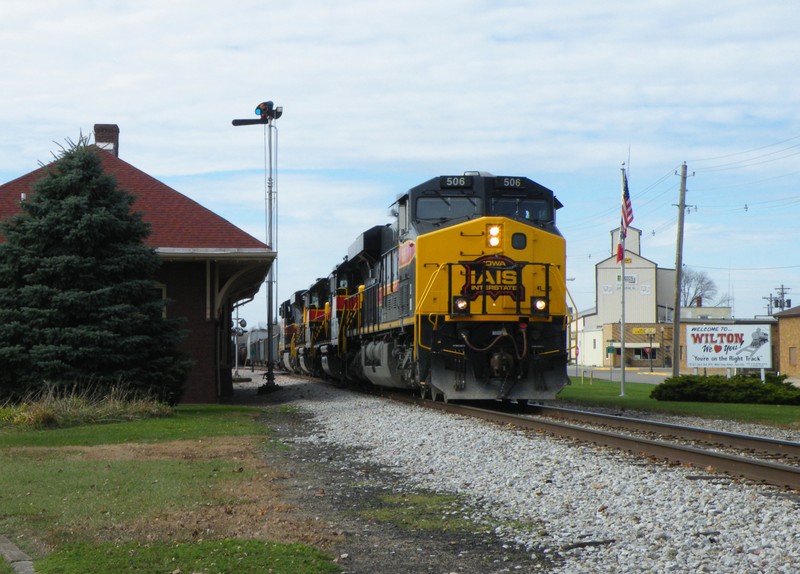 Rollin' right along, 506 makes great time by the depot in Wilton, IA.
