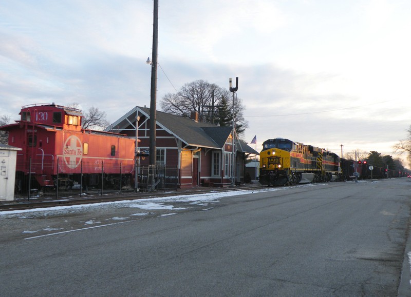 Iowa 512 has the coal train in control as they head back north passed the restored depot and caboose in Chillicothe.