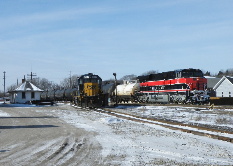 Iowa 513 takes the Seneca block and heads east past CSX's local power and the unrestored RI depot in Seneca.