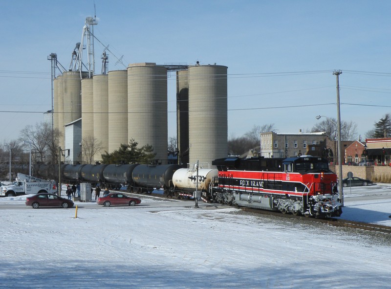 Iowa 513 rolls east through Minooka and by a whole slew of railfans.