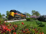 Spring is in full bloom, pun intended, as Iowa's BUSW rolls toward Mossville with the empty CRPE coal train.