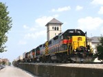 The west train cruises down 5th Street in Davenport, Iowa with 702 pointing the way  August 9 2005.