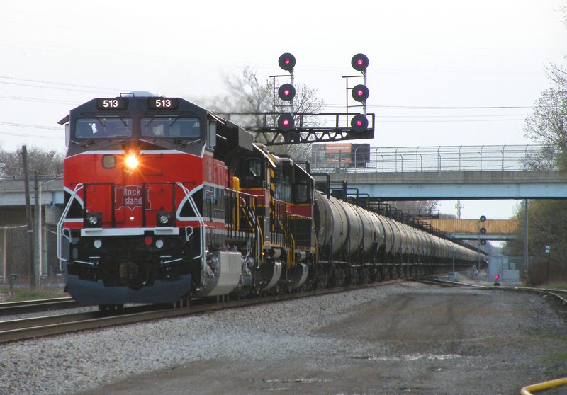 Iowa 513 shoves its loaded ethanol train through the plant at Robbins and under a vintage RI cantilever. All four that remain on the line are located within this mile long plant just southwest of Blue Island. 04-03-10