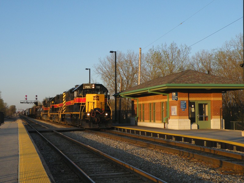 Iowa 705 rolls past the modern Robbins Metra depot as their mile long manifest just about clears Burr Oak Yd. 04-09-10