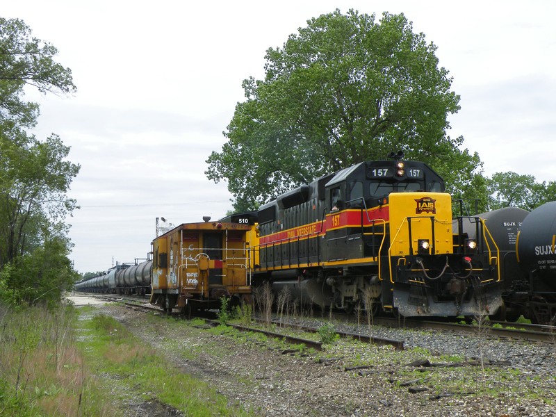 Iowa 157 passes the old Chessie bay window caboose CSX keeps on hand in Rockdale. 05-18-10