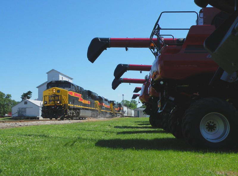 The tracks swing more westwardly in Henry as the first train in 2 days kicks up some dust at the grade crossing.