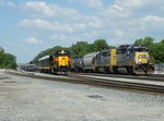 A CSX ethanol train departs Riverdale Yd for points east while IAIS Business train with CF&E crew X540 holds for two on the Harbor...