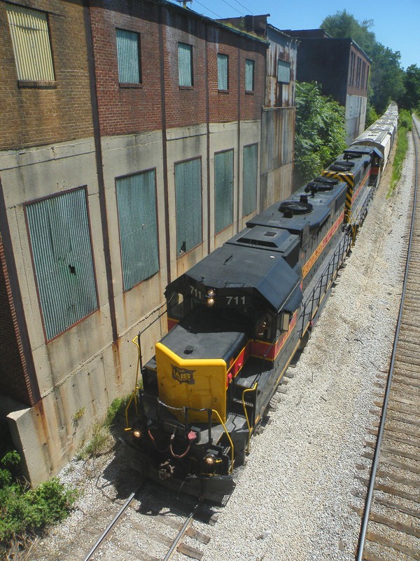 Thundering upgrade, the two GP38-2's are wide open pushing hard on the 18 loads of cement for Buzzi.