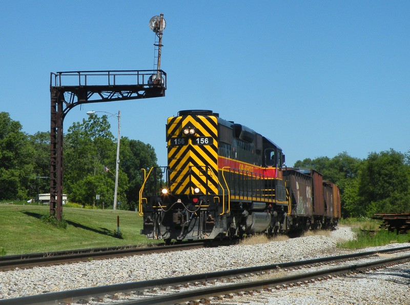 Work 156 backs its mty ballast train down the main and under an old RI cantilever!