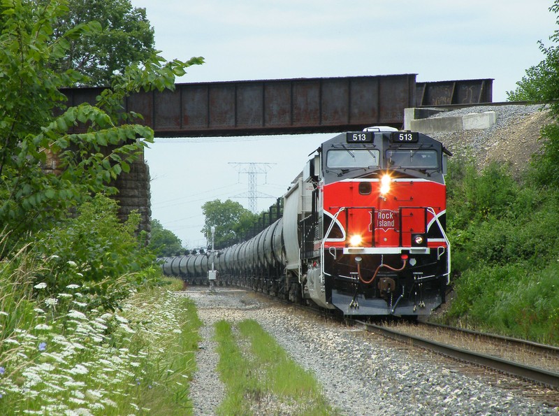 Iowa 513 leads Z026 14 down the CSX in Minooka as the train ducks under the former EJ&E. This was a Menlo load, MEBIU. 07-15-10