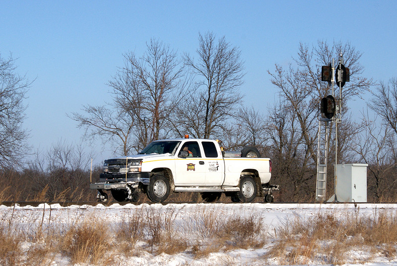 The hi-railer passes the east switch and signal at Yocum.