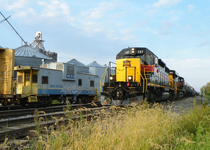 A slightly wider angle shows the 157 east passing CSX's transfer caboose tucked away in the Seneca house track.