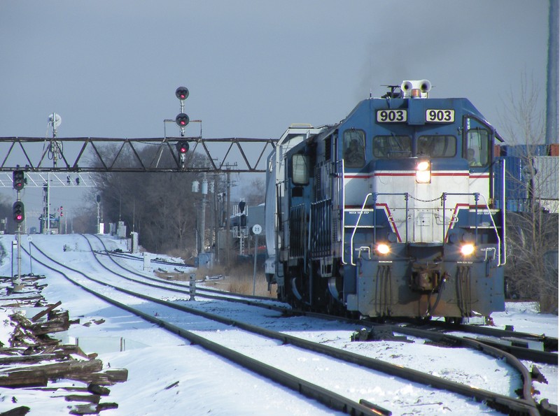 Central Kansas GP9u 903 leads CRL GP10 15 ona fairly lengthy train for interchange with the IAIS at Bur Oak Yd. We are at Gresham, where a RI branch line cut of from the mainline. This was just before Metra took down the old Rock bridge and signals. 01-02-10