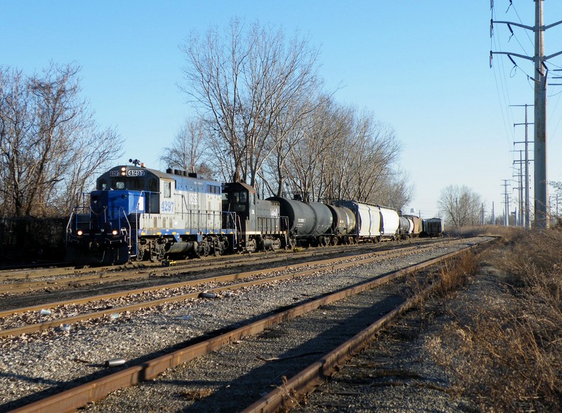 Omnitrax Switching Services GP7 4297 and ex IC SW14 1460 work a cut of cars along S. Torrence Ave. 03-05-10