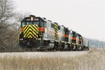 626 leading three units approaches the crossing east of Oxford, Iowa in this mid December 2006 photo.