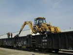 Moving the backhoe to the next car.