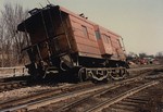 The result of a Milwaukee steel side caboose parked to close to a switch.