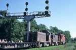 An eastbound EJ&E local passes under the iconic R.I. signal cantilever(s) at Bureau, IL. Photo by John Dziobko