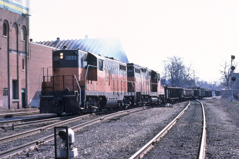 Milwaukee Road service on the former Rock between Davenport and Iowa  City as a short train for North Star Steel in Wilton has finished it's reverse move out of West Dav yard and begins the assault up the hill in Davenport. March 1981. Photo by John Dziobko