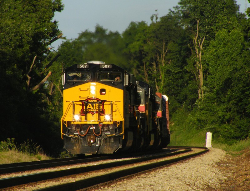 The train turns into the sun along Rte 30 as they begin the descent into the Joliet river valley. 06-14-09