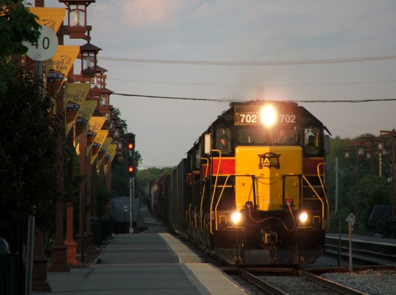 Iowa 702 grumbles through Tinley Park, IL with 3 more GP38-2's and a mile of manifest. This was quite literally the only sun spot left! 05-31-08