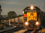 A shot that I've been wanting to knock off for such a long time. Iowa 711 and 3 others swing through the curve in New Lenox with the old Wabash bridge in the background. 06-07-08