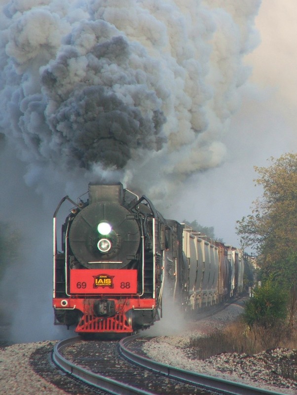 On the approach to West Liberty, Iowa 6988 and 7081 have full heads of steam and are working har dto keep their manifest moving in the early morning fog.